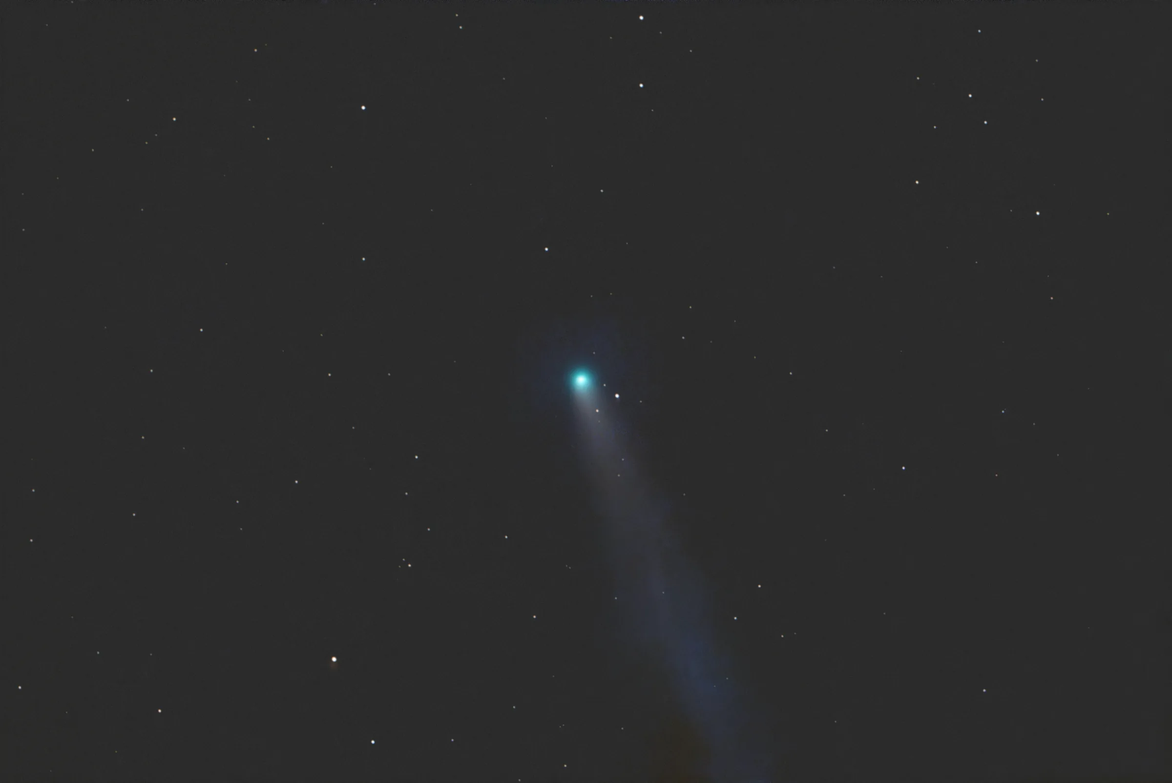 Comet C/2025 R3 as a compact green coma against a field of stars.
