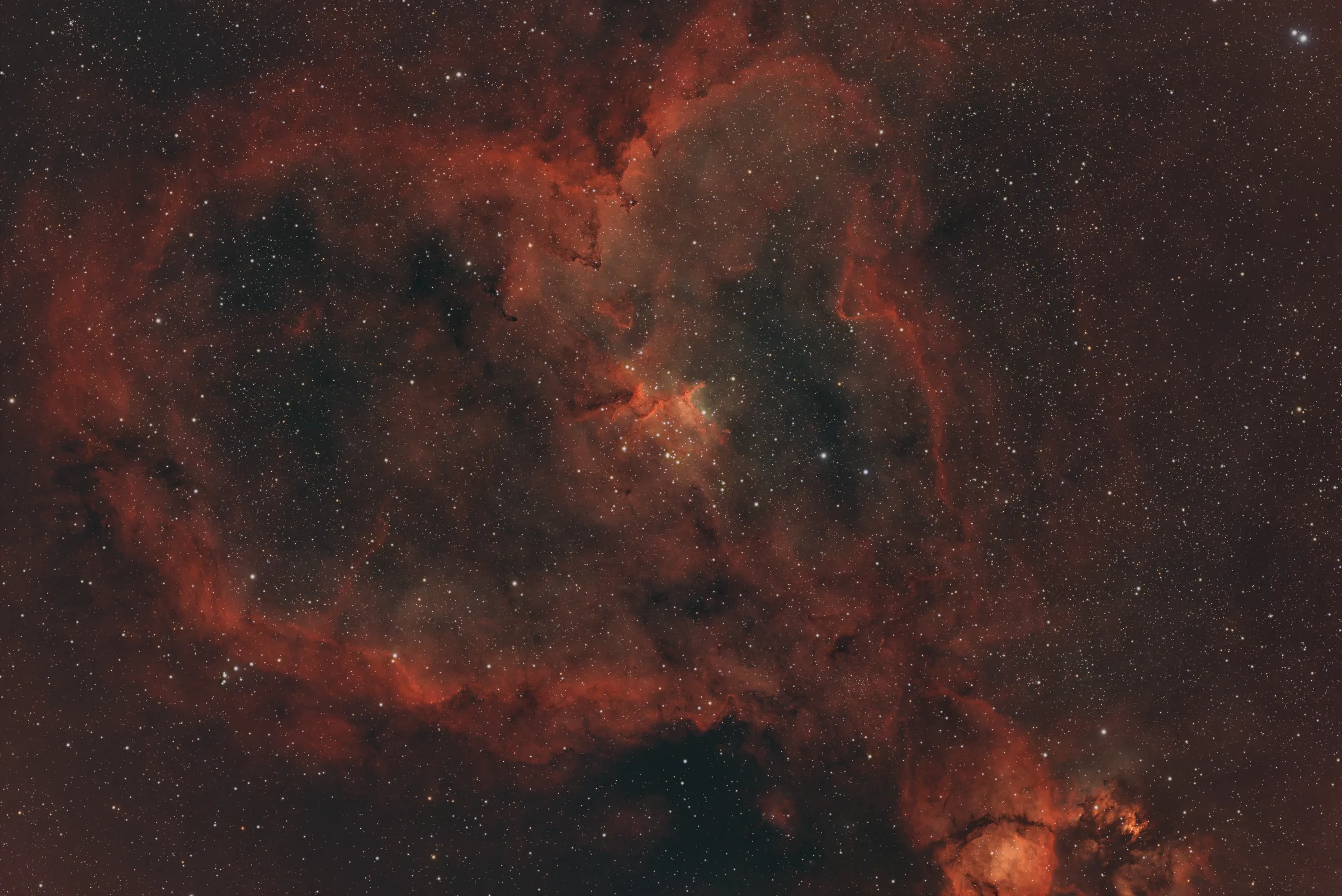 The Heart Nebula, a wide field of red hydrogen emission around a central star cluster.