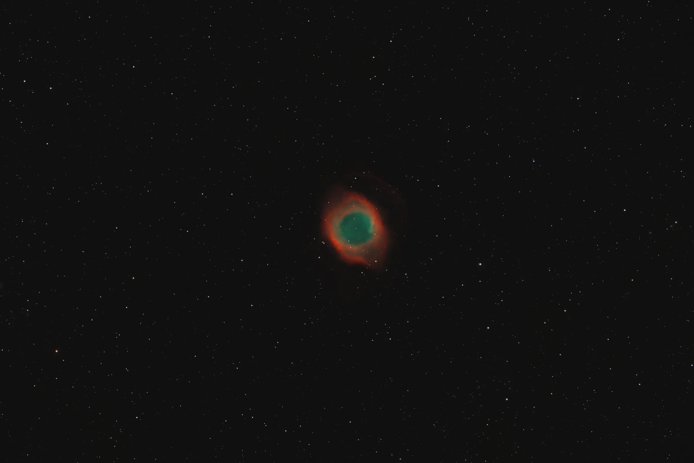 The Helix Nebula, a ring-shaped planetary nebula with a blue-green interior.